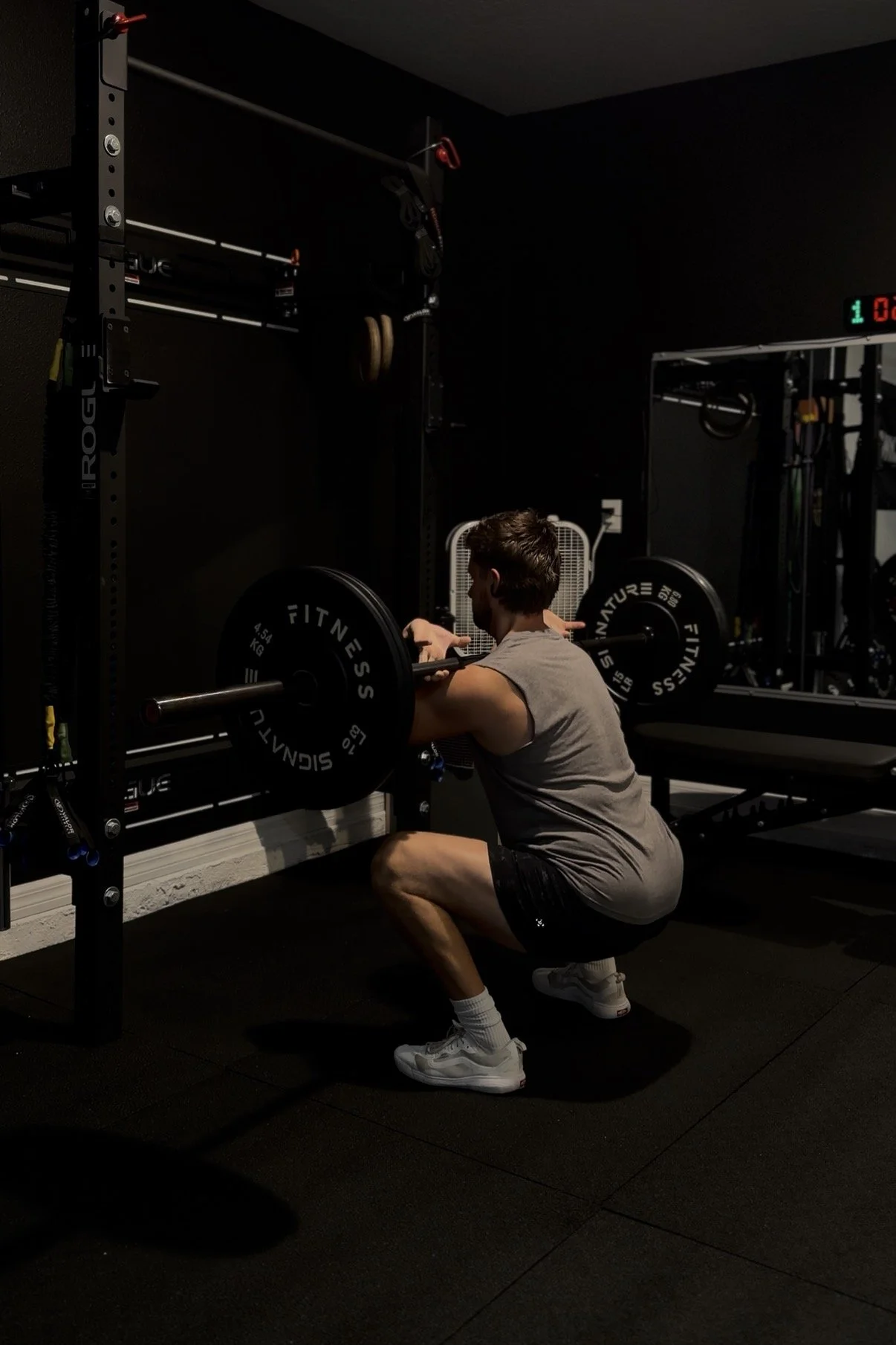 Mitch at the bottom of a back squat in his garage gym